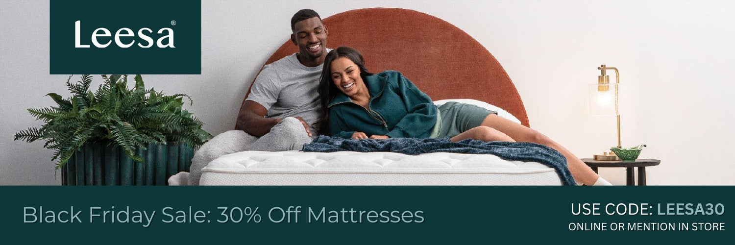 Couple lying on a Leesa mattress with promotional text for a Black Friday sale save 30% with code or mention in store. code Leesa30